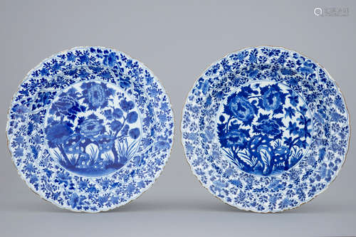 A pair of moulded blue and white Chinese peony & rockwork dishes, Kangxi