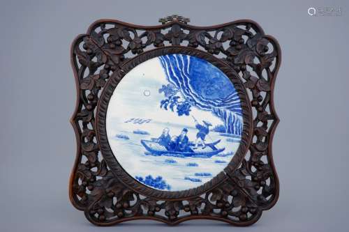 A Chinese blue and white plaque in sculpted frame, 19th C.
