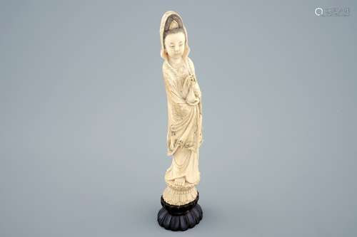 A Chinese carved ivory figure of Guanyin on a wooden base, 19th C.