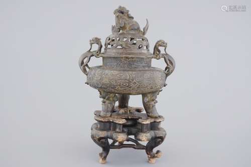 A large Chinese bronze tripod censer on stand, 17/18th C.