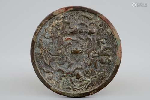A Chinese bronze mirror with floral design, prob. late Ming Dynasty
