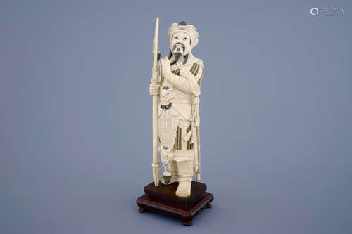 A Chinese carved ivory figure of a warrior on a wooden base, late 19th C.