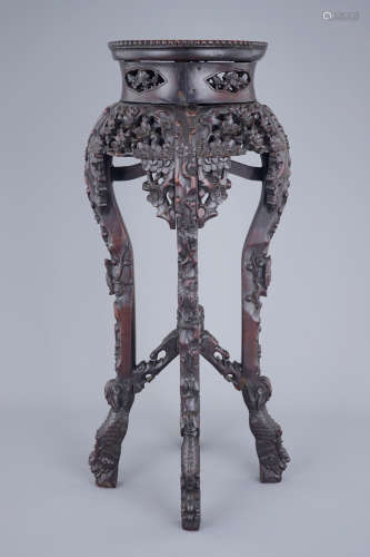 A richly carved Chinese wood stand with marble top, 19/20th C.