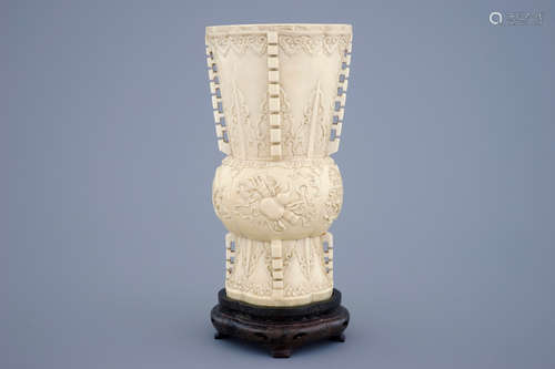 A Chinese carved ivory vase of archaic form on a wooden base, 19th C.