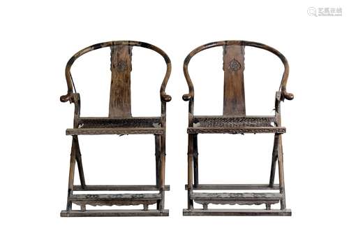 A pair of hardwood folding chairs