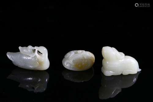 A set of three white jade carvings