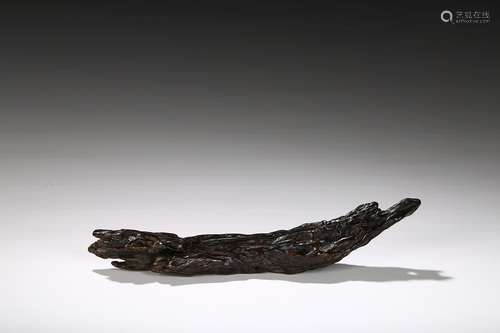 An agarwood natural form brush rest