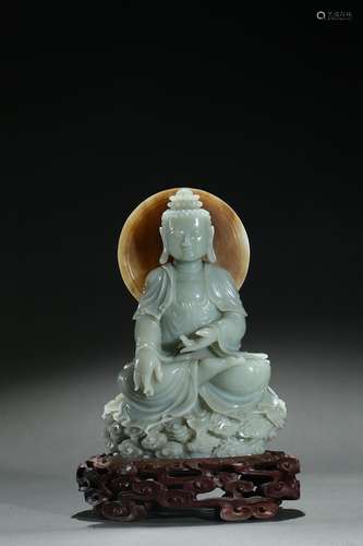 A greenish-white jade carved shakyamuni statue