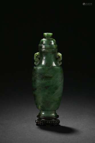 A spinach green jade carved hu-form vase with cover