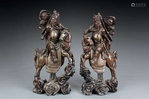 A pair of wooden Guanyu on horse carvings inset with silver lines