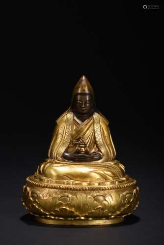 A gilt-bronze figure of guru