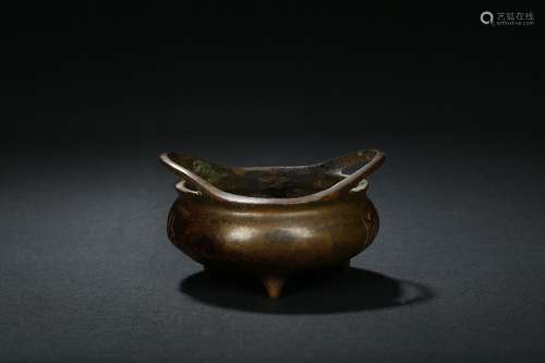 A bronze tripod censer