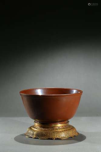 A cafe-au-lait glazed bowl with gilt bronze stand