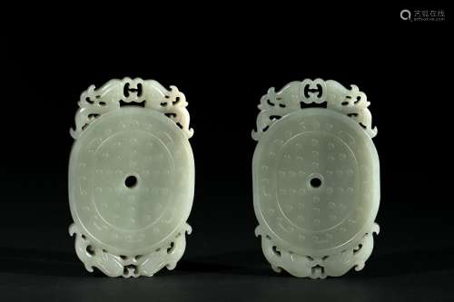 A pair of celadon jade pendants