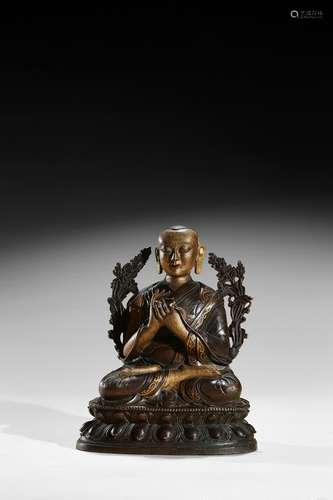 A bronze parcel-gilt figure of Lama