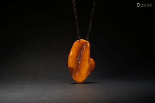 A naturalistic amber pendant
