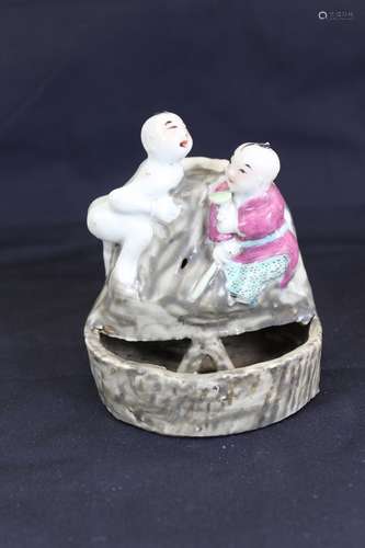 A porcelain statue of two kids