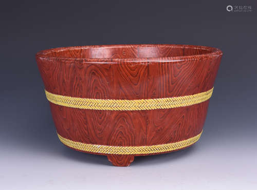 A WOODEN BASIN WITH PAINTED WOOD GRAIN