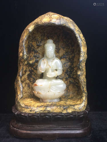 A WHITE JADE GUANYIN IN STONE NICHE