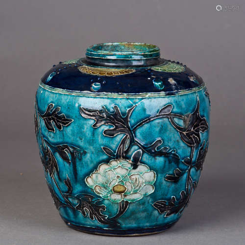 A COBALT GLAZED PORCELAIN JAR WITH FLOWER IN RELIEF