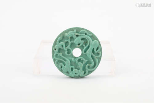 A CHINESE CARVED GREEN PENDANT