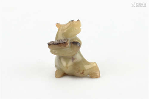 A CHINESE CARVED JADE FOO-DOG