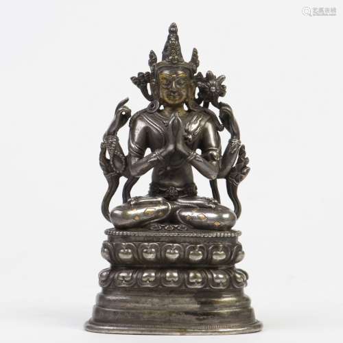 A SILVER AND GOLD-INLAID FIGURE OF FOUR ARMS AVALOKITESHVARA, QING DYNASTY