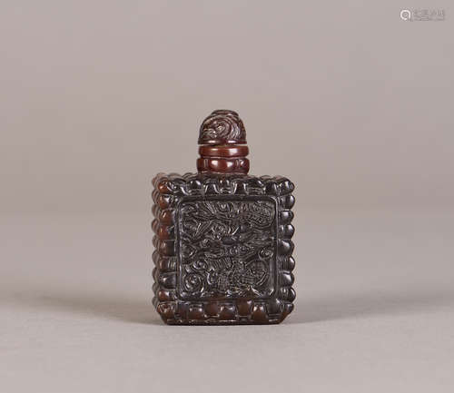 A PEKING GLASS SNUFF BOTTLE WITH DRAGON RELIEF