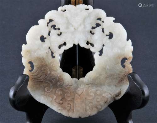 Jade disk. China. 18th century. Surface carved with two Kuei dragons flanking a mythical animal. Grey stone with black markings.  4