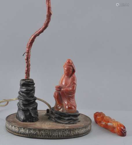 Lot of two agate carvings. Late 19th century. A figure of the Goddess of Mercy Kuan Yin mounted as a lamp and a garment hook carved with dragons. Each about 4-1/2