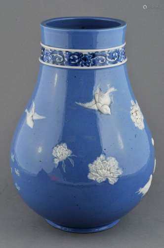 Porcelain vase. Japan. 19th century. Pate sur pate decoration of a white birds and flowers on a lavender ground. Band of underglaze blue scrolling around the neck. Signed in seal characters on the base. 11-3/4