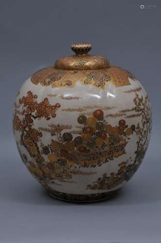 Pottery vase. Japan. Meiji period. (1868-1912). Satsuma ware. Decoration of flowering plants in red, gosu-blue and green enamels with gilt. Brocade borders and top. Melon shaped body. Signed within a cash coin cartouche. 11