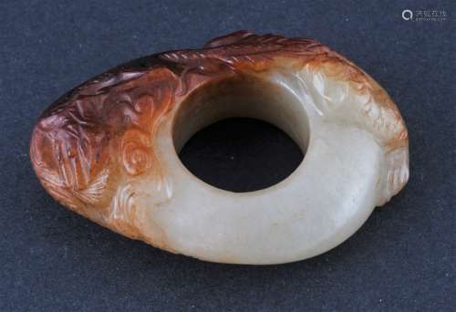 Jade Archers ring. China. 18th century. White stone with a large russet marking. Surface carved with a dragon and a tiger.  2-1/2