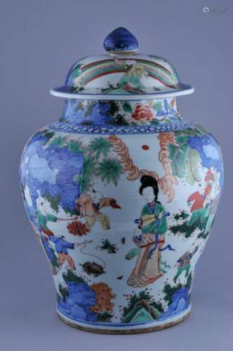 Porcelain covered jar. China. 20th century. Baluster form. Wu Tsai decoration of women and children playing in a garden. 17-1/2