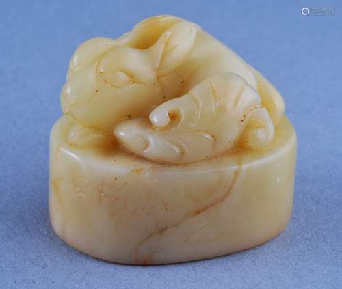 Soapstone seal. China. 19th century. Ivory coloured stone. Oval form. Rabbit finial. 1-3/4