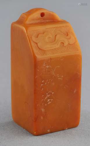 Soapstone seal. China. 19th century. Yellow coloured stone. Weight shaped. Archaic dragon on one shoulder. 2