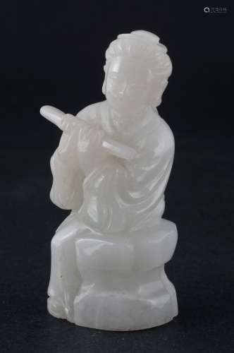 Jade  carving. China. 20th century. White stone carving of a seated woman playing a flute. 2-1/2