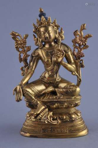 Gilt bronze Image. China. Ch'ien Lung mark (1735-1795) and of the period. Seated figure of Tara. 6-1/2