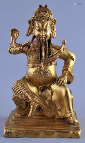 Gilt bronze Image. China. 18th/19th century. Seated figure of a Buddhist Heavenly General. 6-1/2