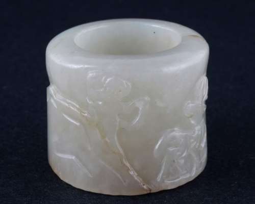 Jade Archers ring. China. 19th century. Grey stone. Surface carved with a monkey and a deer. 1