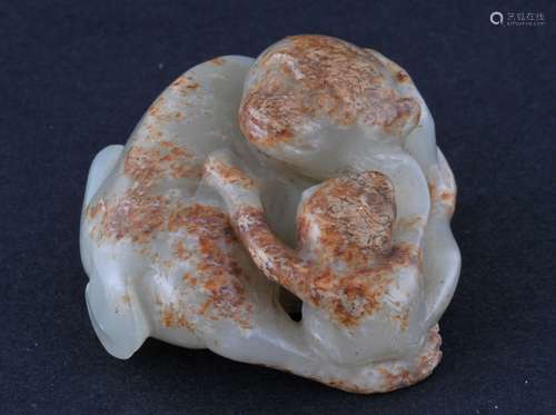 Jade carving. China. 19th century. Stone of a celadon colour with tan skin. Study of a monkey and its infant. 2-1/2