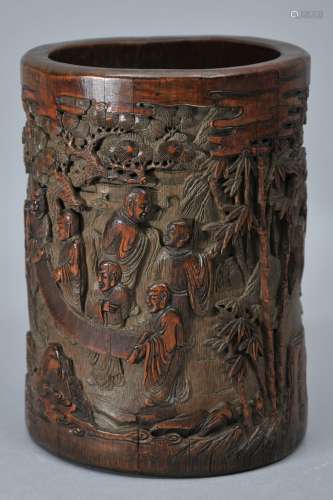 Bamboo brush pot. China. 18th century. Surface carved in high relief with the eighteen Luohans in a garden. Signed by a member of the Wu family. 6