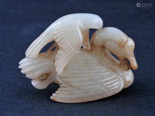 Jade finial. China. Yuan period. (1279-1368). White stone with russet shading. Carving of a hawk attacking a swan. 2