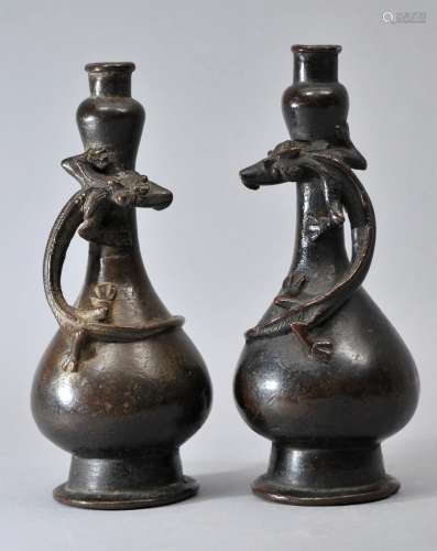 Pair of Yuan/Ming Dynasty Chinese double gourd form bronze vases with climbing chilong dragons. Bases missing. One vase repaired at center. Dark brown patina. 7