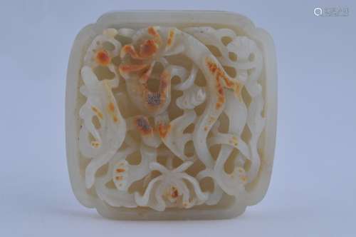 Jade Belt Plaque. China. Yuan to early Ming period. White jade with russet markings. Square form with rounded corners. Surface carved with a dragon and lotus motif. 2-1/2