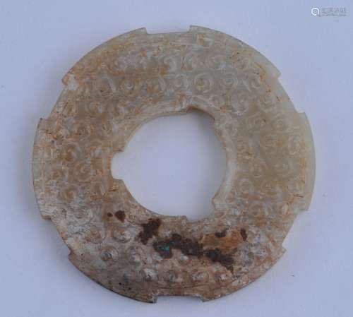 Archaic Ritual Disk. China. Han period. Highly calcified grey white with concretions including malachite inclusions. Notches edge and interior. Surface carved with coma marks. 2-1/2