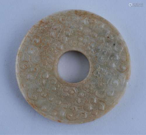 Archaic Ritual Disk. China. Han period. Ivory colored stone from calcification. Surface finely carved with coma scrolling. 1-3/4