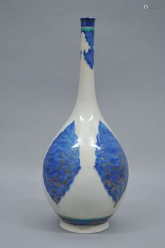 Pottery vase. Persia. 18th century. Bottle form. Underglaze blue and turquoise Arabesque decoration with gilt flowers. 18-1/2