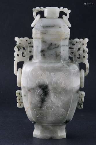 Jade covered jar. China. 19th/20th century. Sea green stone with forest green. Octagonal shape with the surface carved with dragons. Dragon handles with jump rings. 7-1/2