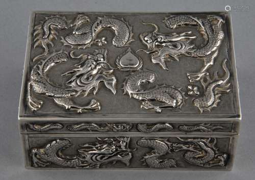 Silver box. China. 19th to early 20th century. Rectangular form. Repousse decoration of dragons. Signed Wang Hing. 4-1/4